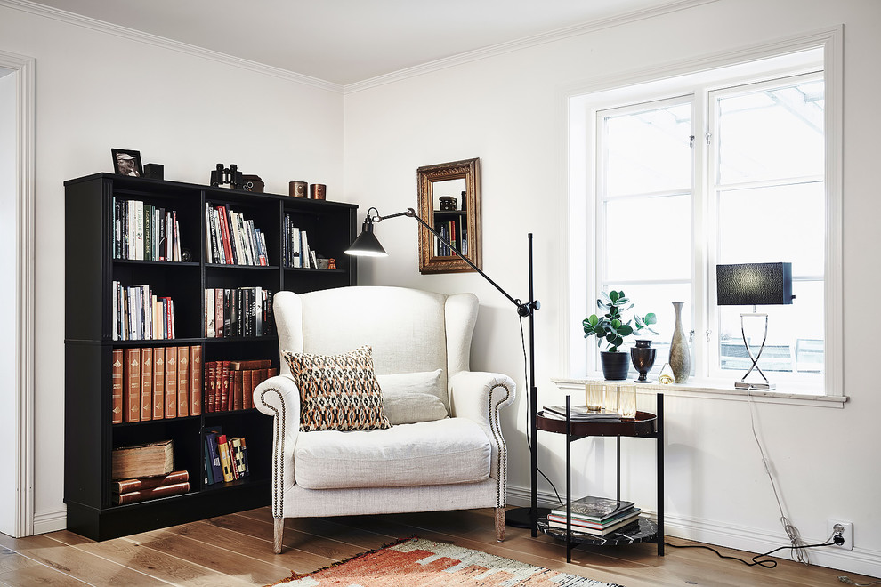 Photo of a large scandi formal enclosed living room in Gothenburg with white walls, light hardwood flooring, no tv and brown floors.