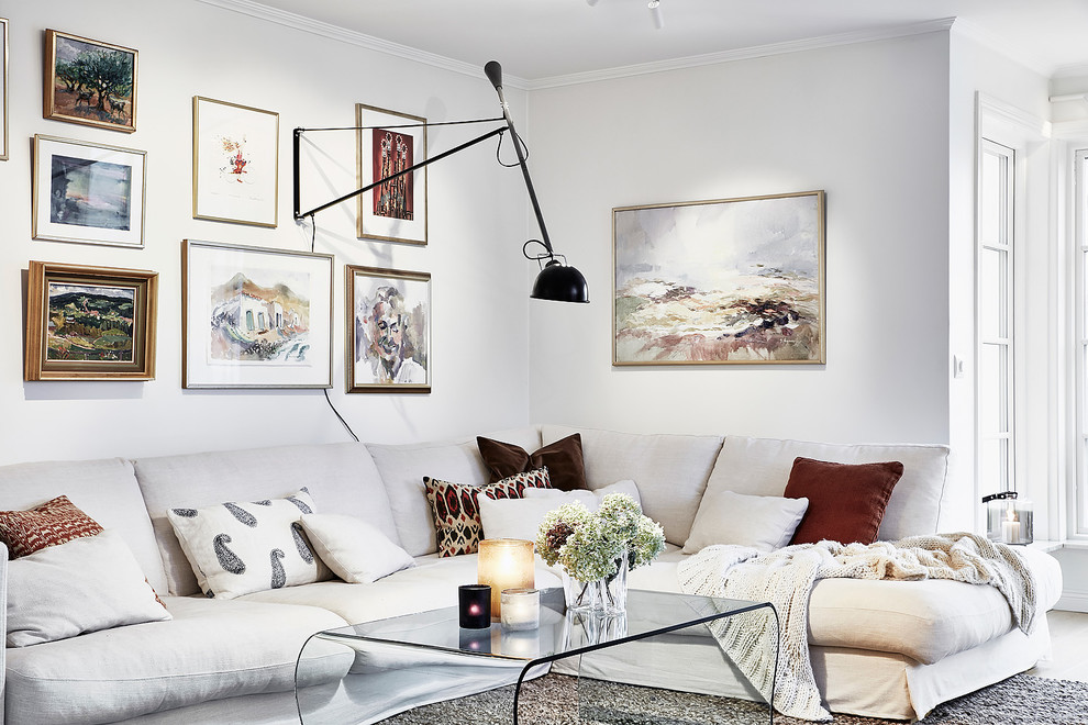 Example of a large danish formal and enclosed light wood floor and brown floor living room design in Gothenburg with white walls and no tv