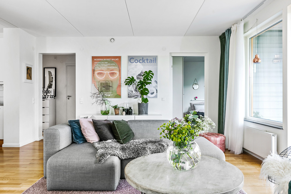 Idéer för ett mellanstort skandinaviskt separat vardagsrum, med vita väggar, mellanmörkt trägolv och beiget golv