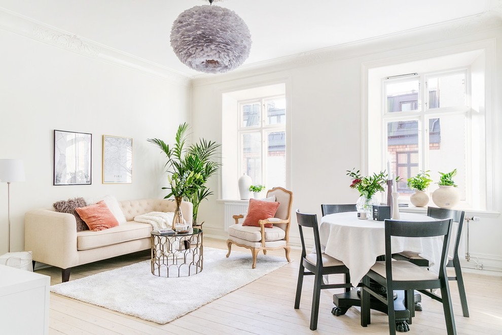 Inspiration for a mid-sized scandinavian open concept light wood floor and beige floor living room remodel in Gothenburg with white walls and no fireplace
