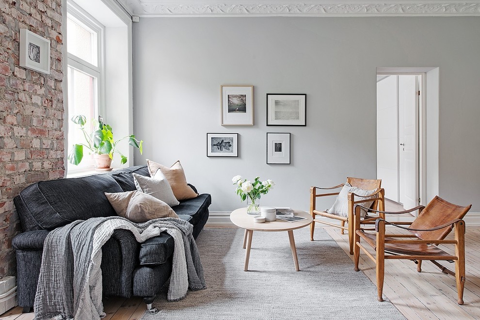 Medium sized scandinavian formal enclosed living room in Gothenburg with grey walls, light hardwood flooring, no fireplace and no tv.