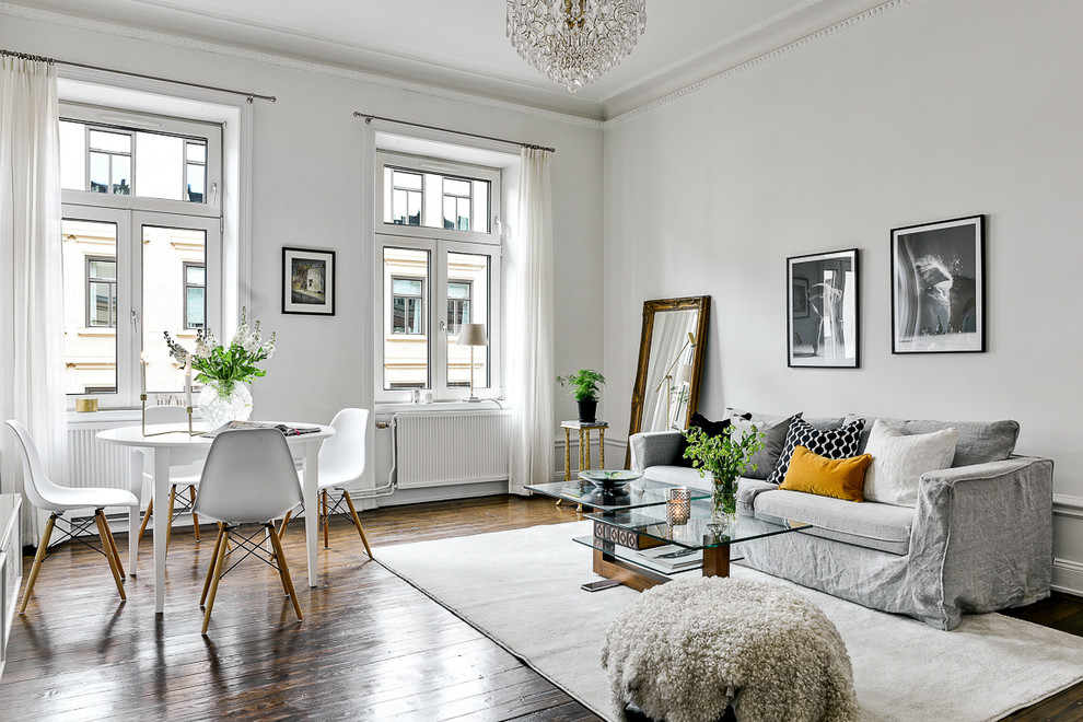 Medium sized scandinavian formal open plan living room in Stockholm with white walls, medium hardwood flooring and no tv.