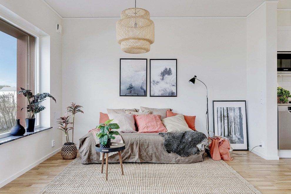 Inspiration for a small scandi enclosed living room in Other with white walls, light hardwood flooring and beige floors.