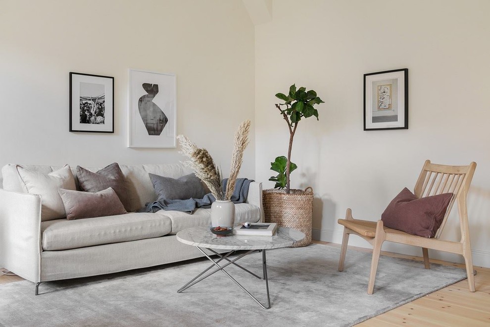 Inspiration for a scandi living room in Stockholm with beige walls, light hardwood flooring and beige floors.
