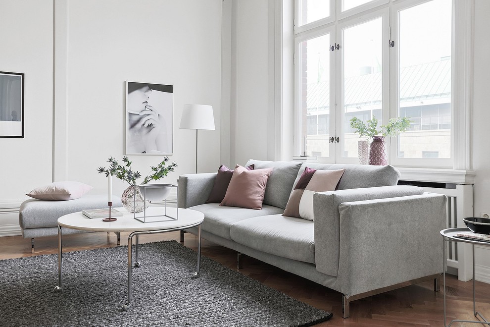 Trendy formal and enclosed medium tone wood floor and beige floor living room photo in Malmo with white walls