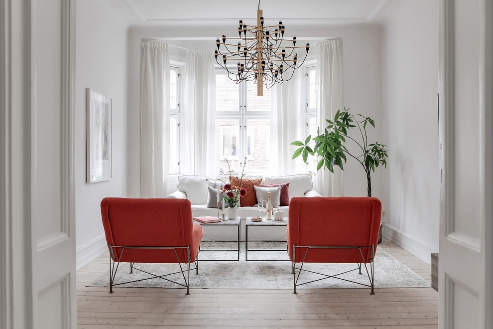 Inspiration for a mid-sized scandinavian formal and enclosed light wood floor and beige floor living room remodel in Malmo with white walls, no fireplace and no tv