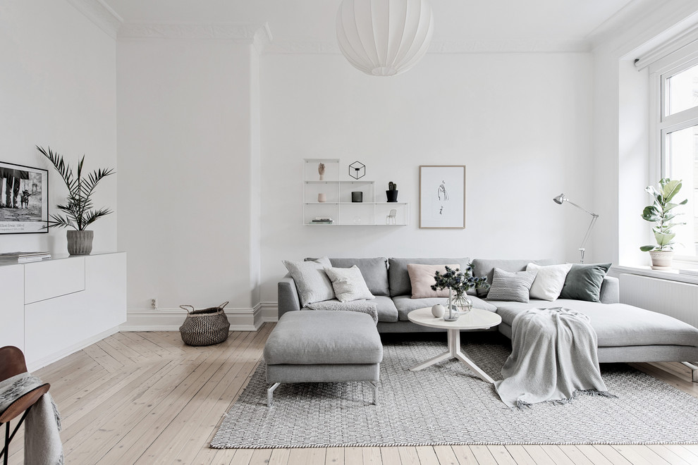 Idee per un grande soggiorno scandinavo chiuso con pareti bianche, parquet chiaro e pavimento beige