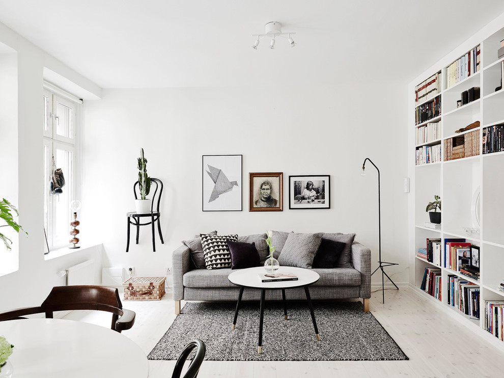 Living room - large scandinavian formal and open concept light wood floor living room idea in Gothenburg with white walls, no tv and no fireplace