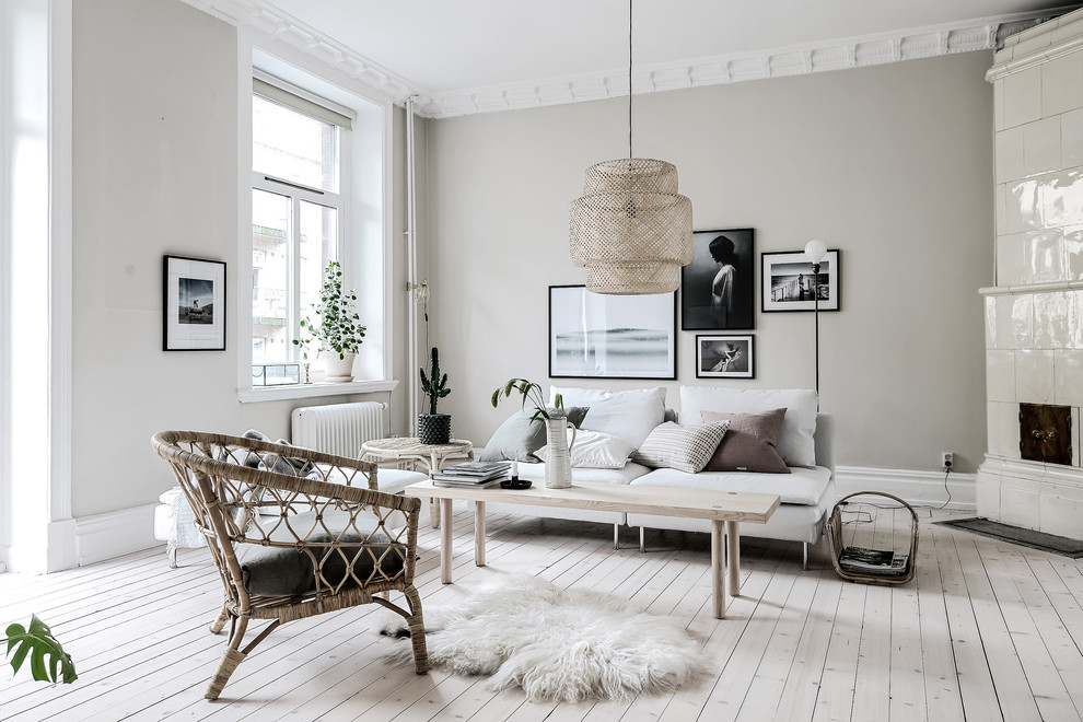 This is an example of a scandinavian living room in Gothenburg with beige walls, light hardwood flooring and beige floors.