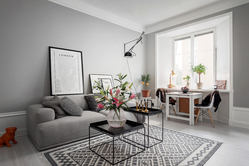 Large danish formal and open concept light wood floor living room photo in Stockholm with gray walls and no fireplace