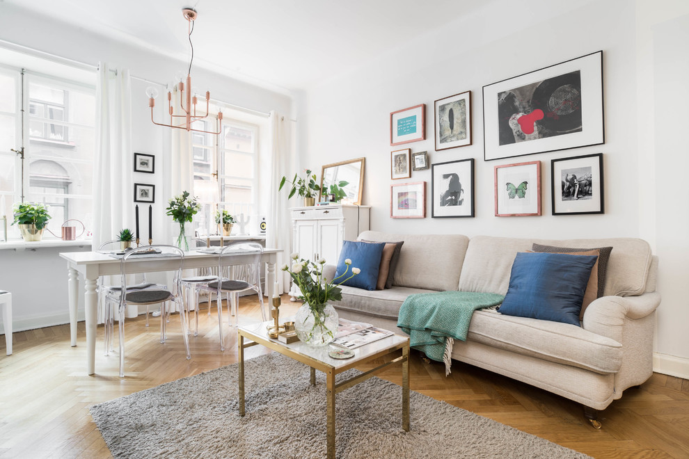 Inspiration for a large scandinavian open concept and formal medium tone wood floor living room remodel in Stockholm with white walls