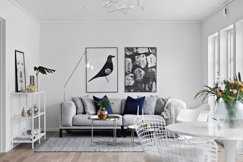 Small danish open concept and formal medium tone wood floor and beige floor living room photo in Other with white walls and no fireplace