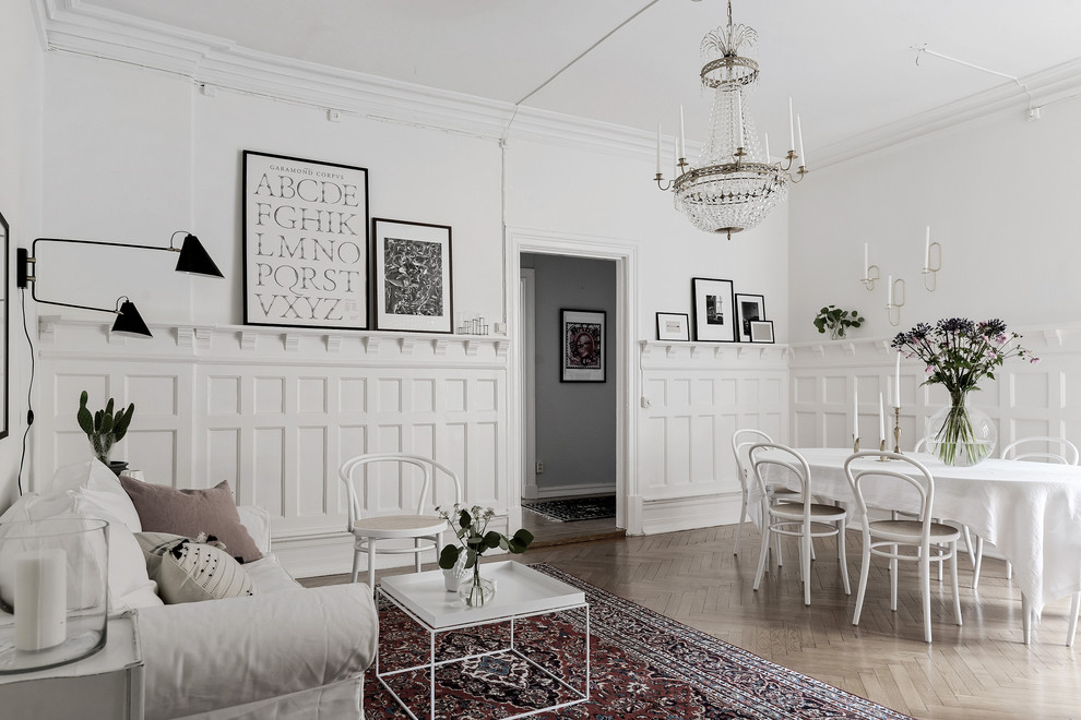 Large scandi open plan living room in Gothenburg with white walls, medium hardwood flooring and brown floors.