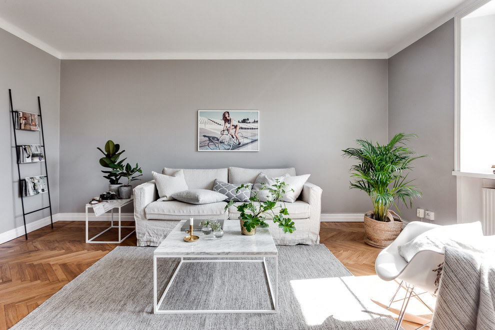 Inspiration for a mid-sized scandinavian formal and open concept light wood floor living room remodel in Stockholm with gray walls, no fireplace and no tv