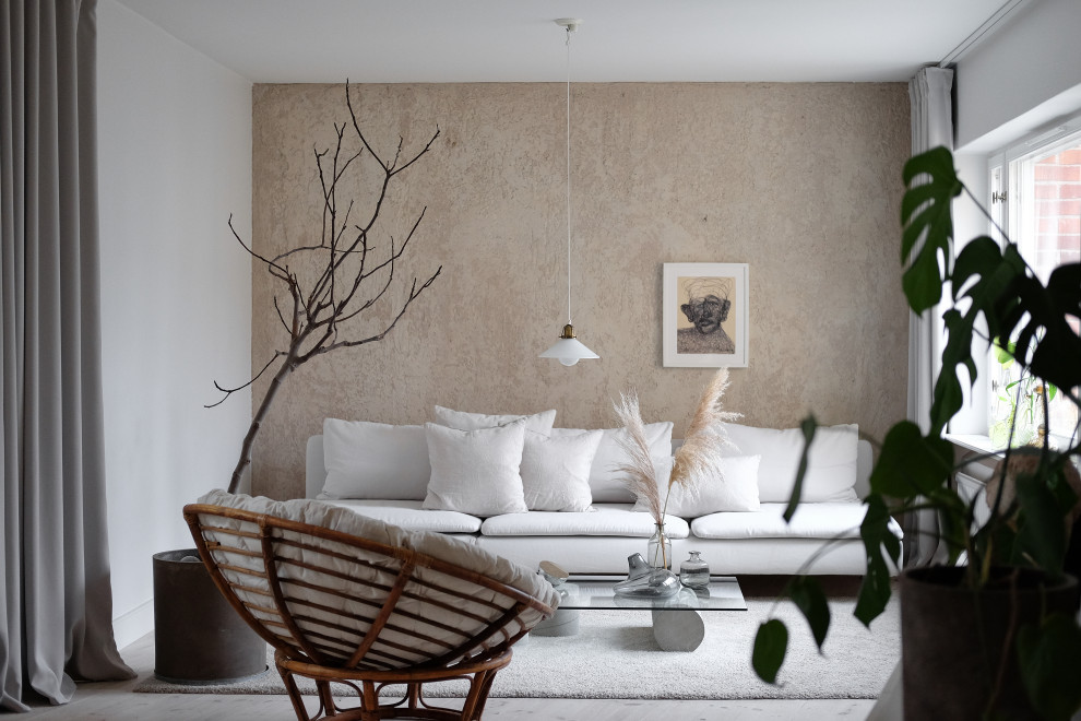 Inspiration for a scandinavian living room in Stockholm with beige walls, light hardwood flooring and beige floors.
