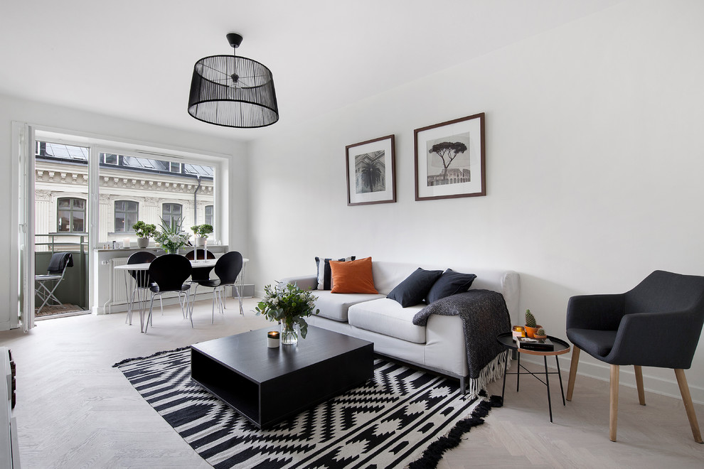 Medium sized scandi formal open plan living room in Stockholm with white walls, light hardwood flooring and no tv.