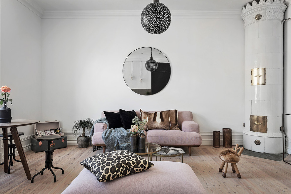 Inspiration for a mid-sized scandinavian formal and open concept light wood floor living room remodel in Stockholm with white walls, a corner fireplace and no tv