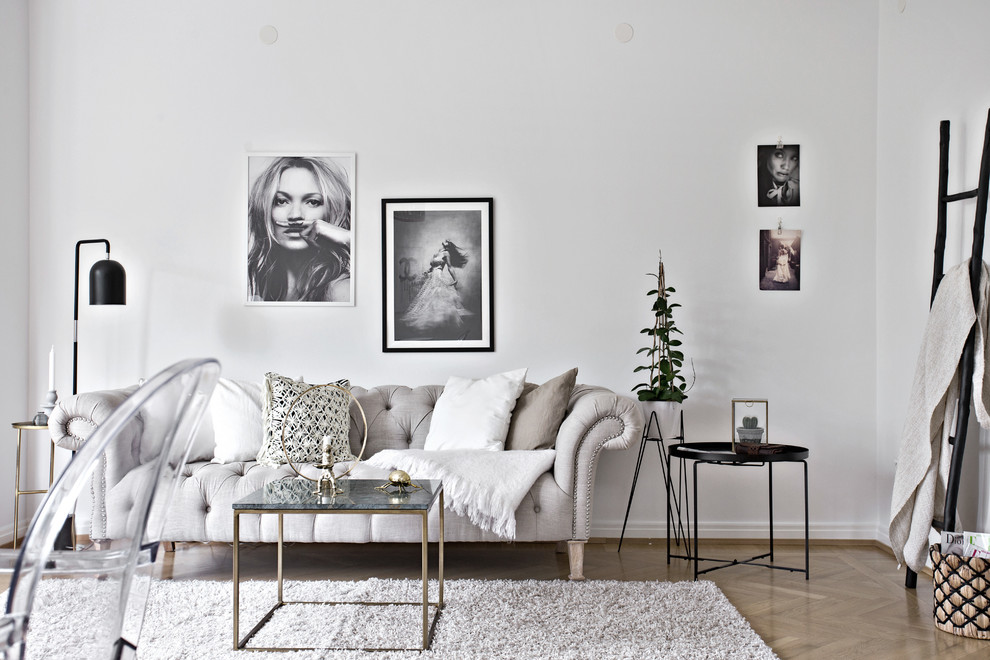 Inspiration for a mid-sized scandinavian formal and open concept light wood floor living room remodel in Gothenburg with white walls and no tv