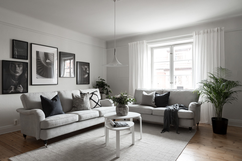 Design ideas for a scandinavian living room in Other with grey walls, light hardwood flooring and beige floors.