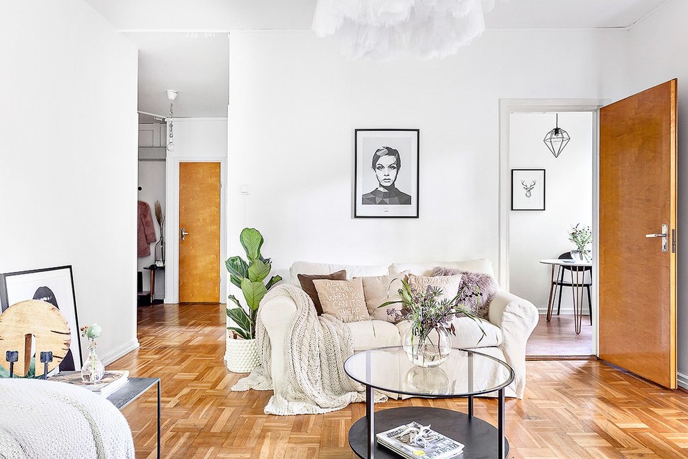Example of a mid-sized danish open concept and formal light wood floor living room design in Stockholm with white walls, no fireplace and no tv