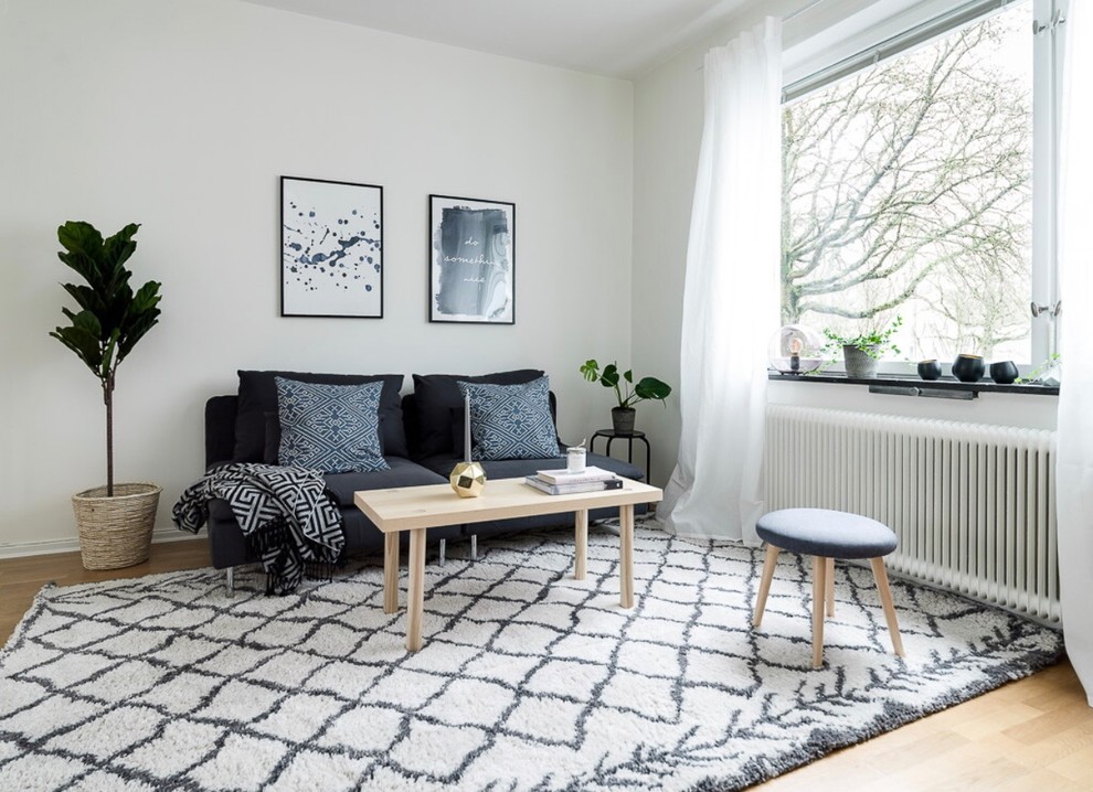 Idéer för att renovera ett skandinaviskt vardagsrum, med vita väggar och ljust trägolv