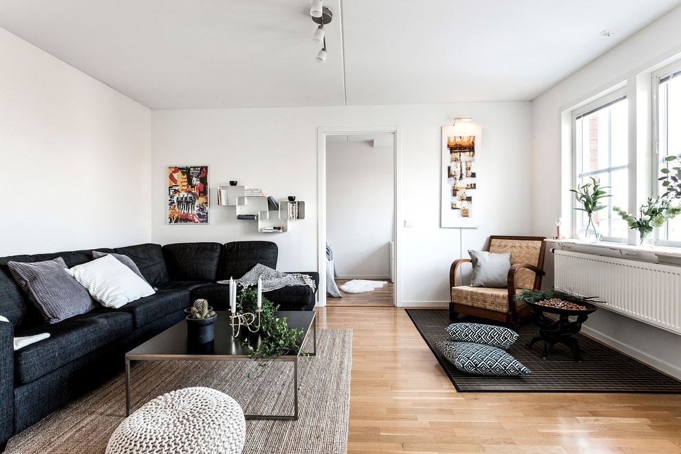 Inspiration for a mid-sized scandinavian formal and enclosed light wood floor living room remodel in Stockholm with white walls