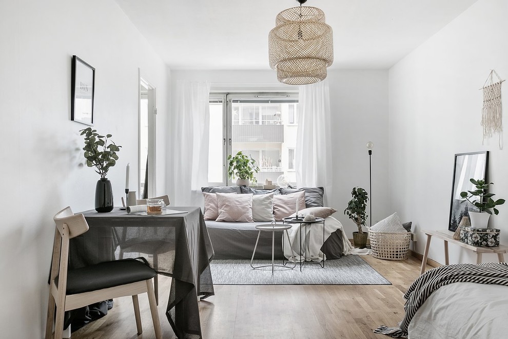 Small danish enclosed light wood floor and beige floor living room photo in Stockholm with white walls