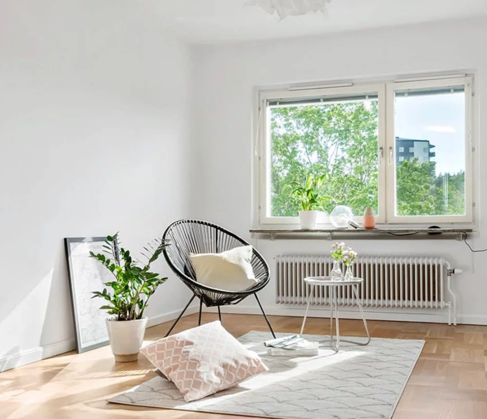 Design ideas for a small scandinavian enclosed living room in Stockholm with white walls, light hardwood flooring and beige floors.