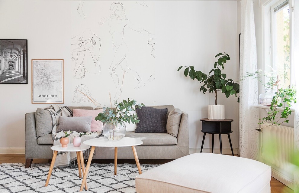 Inspiration for a scandinavian open concept medium tone wood floor living room remodel in Stockholm with white walls