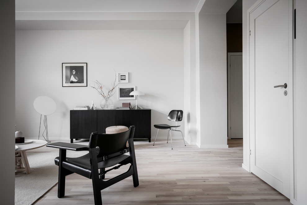 Inspiration for a medium sized scandinavian living room in Gothenburg with white walls and light hardwood flooring.