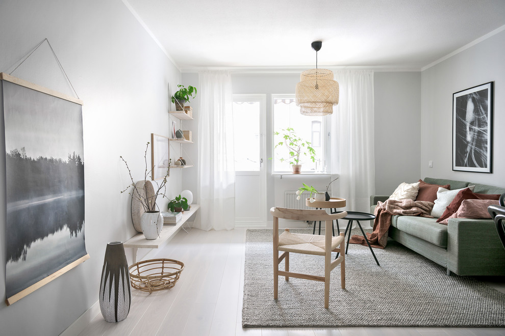 This is an example of a scandinavian enclosed living room in Gothenburg with grey walls, no fireplace, no tv, white floors and painted wood flooring.