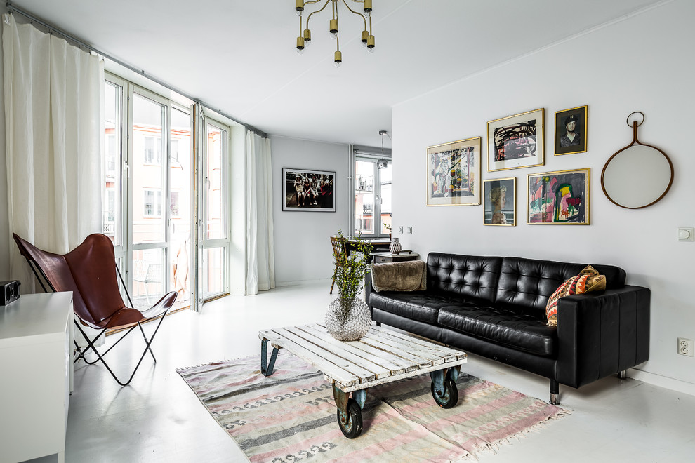 Medium sized scandi living room in Stockholm with white walls, painted wood flooring and white floors.