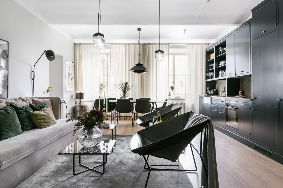Design ideas for a scandinavian open plan living room in Stockholm with grey walls, medium hardwood flooring and brown floors.