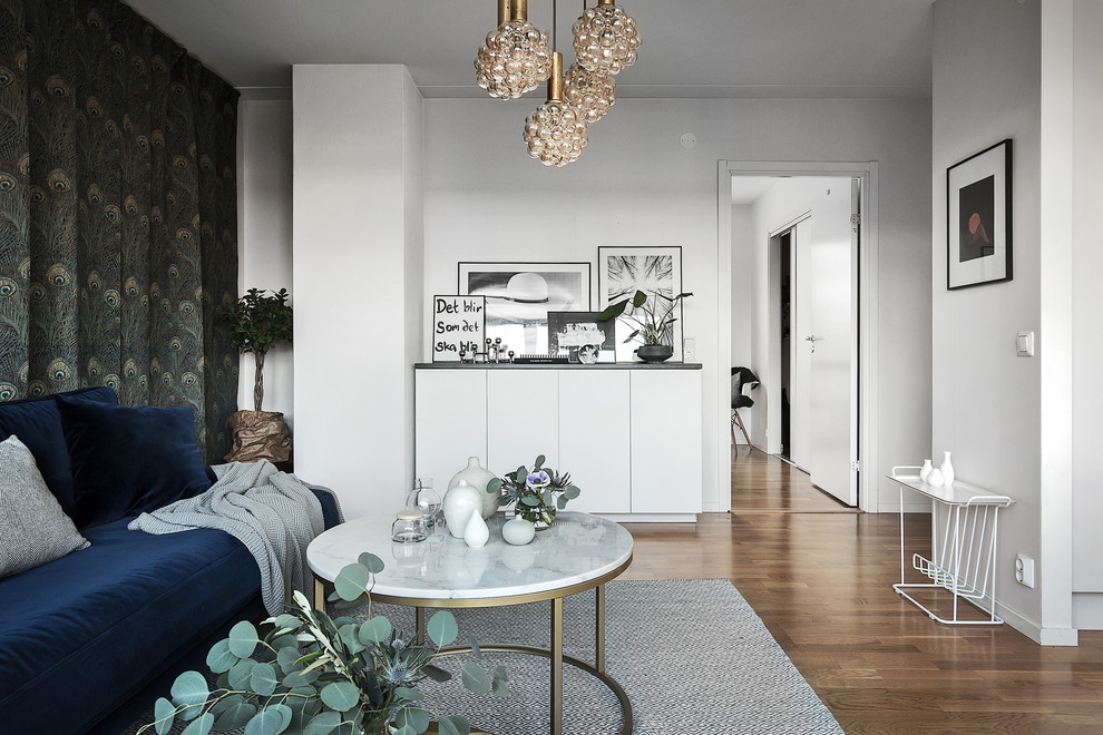 Mid-sized danish formal light wood floor living room photo in Stockholm with white walls, no fireplace and no tv