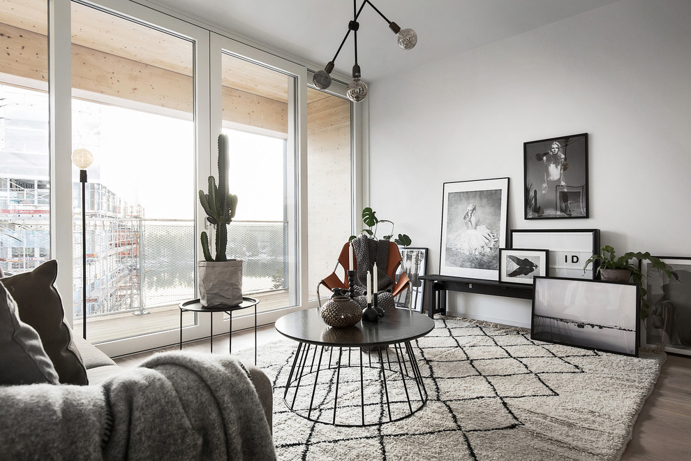 Mid-sized danish light wood floor living room photo in Stockholm with white walls, no tv and no fireplace