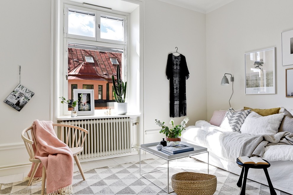 Photo of a large scandi formal living room in Stockholm with white walls and painted wood flooring.