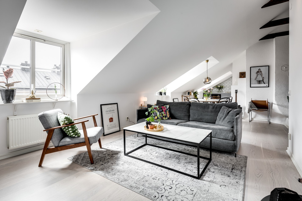 Design ideas for a medium sized scandinavian living room in Stockholm with white walls and beige floors.