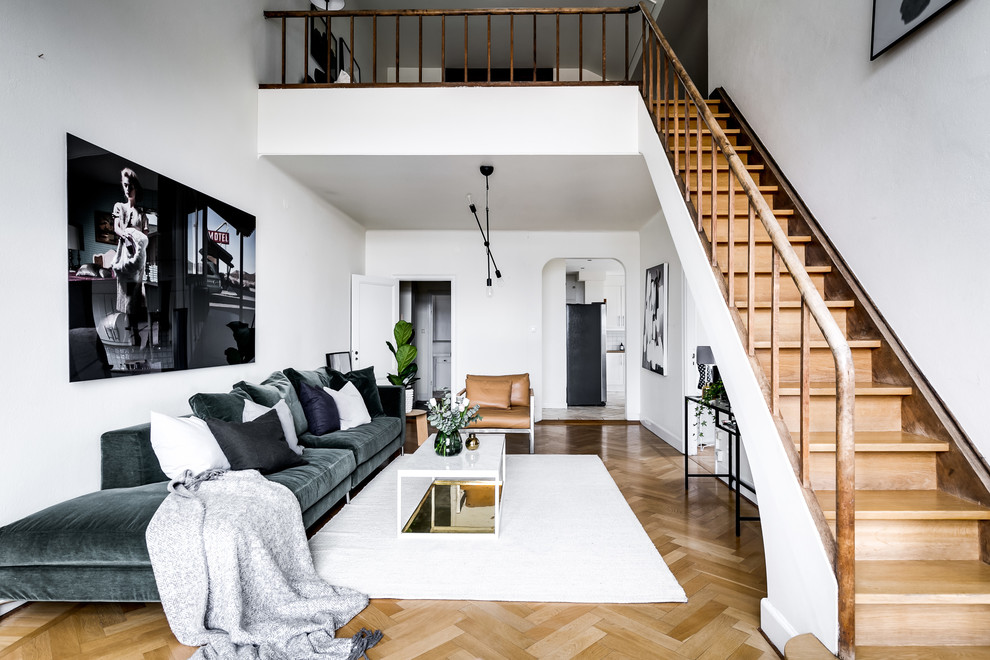 Medium sized scandinavian formal mezzanine living room in Stockholm with white walls, beige floors, light hardwood flooring and no tv.