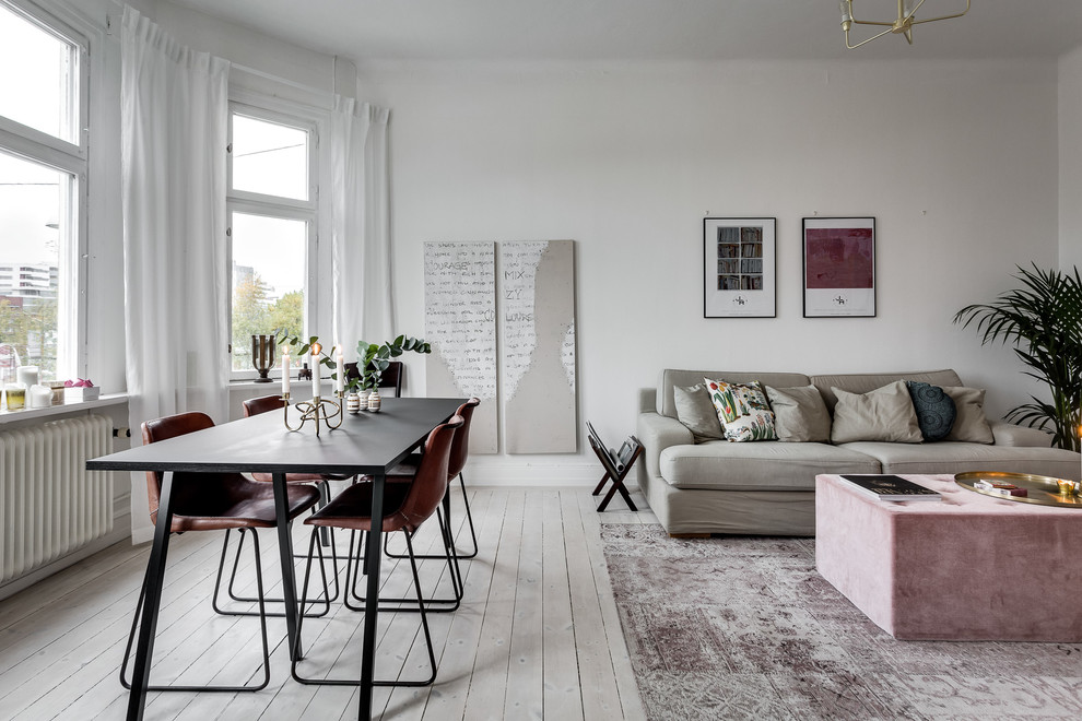 Пример оригинального дизайна: открытая, парадная гостиная комната среднего размера в скандинавском стиле с светлым паркетным полом и белыми стенами без телевизора