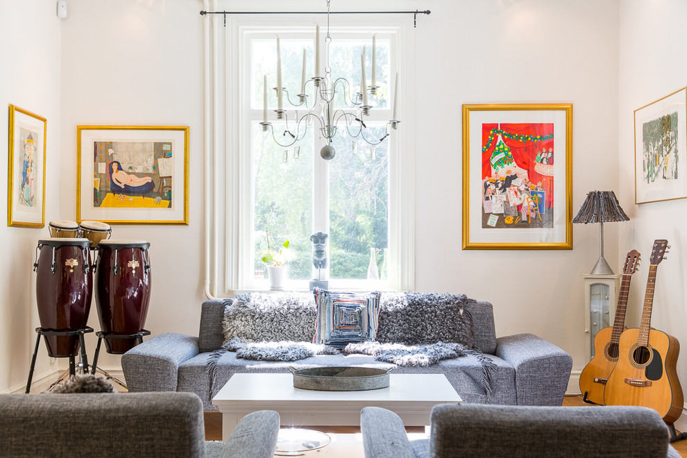 This is an example of a medium sized classic enclosed living room in Stockholm with white walls.