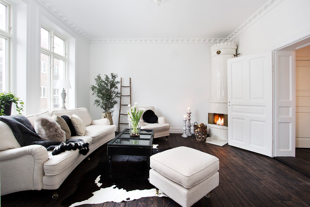 Danish formal and open concept dark wood floor living room photo in Malmo with white walls, a corner fireplace and no tv