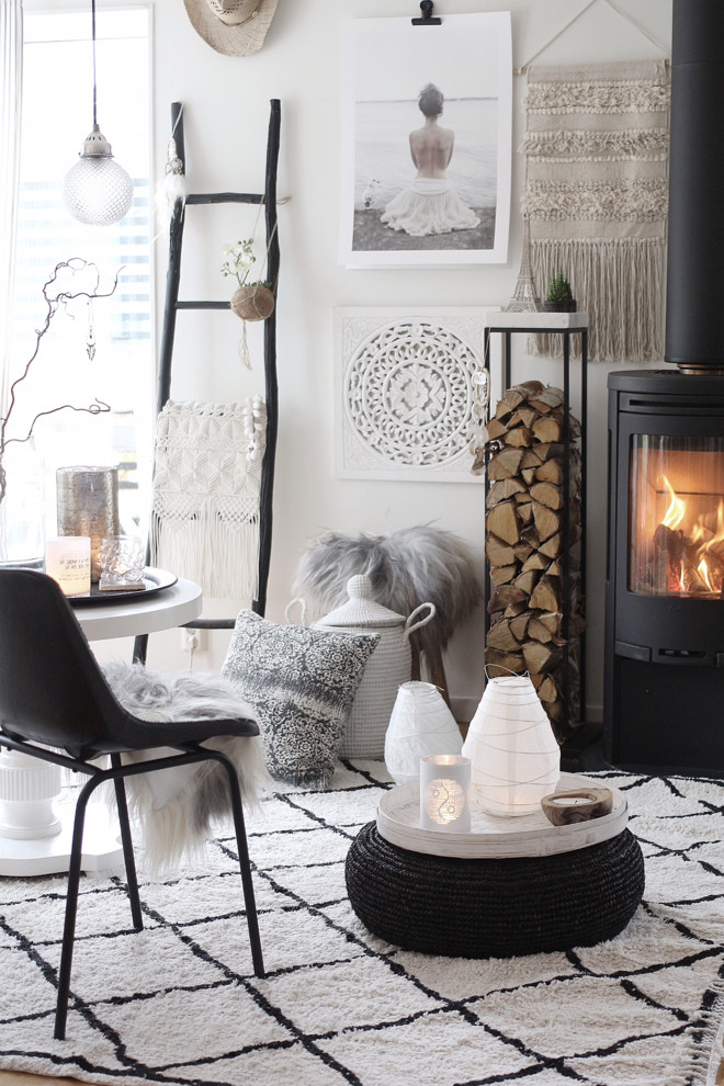 This is an example of a scandi enclosed living room in Stockholm with white walls and a wood burning stove.