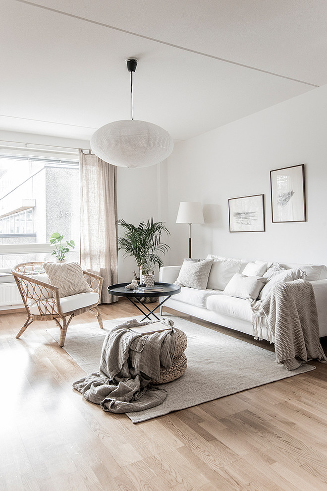 Mid-sized danish enclosed and formal beige floor and light wood floor living room photo in Stockholm with white walls