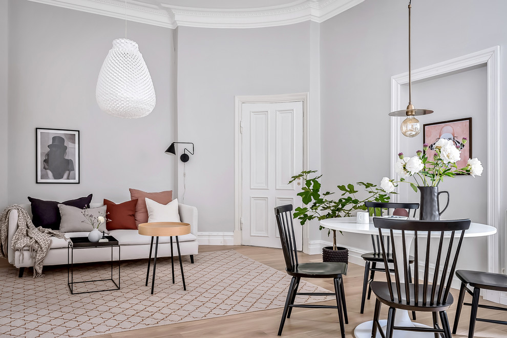 Medium sized scandi open plan living room in Gothenburg with grey walls, light hardwood flooring and beige floors.