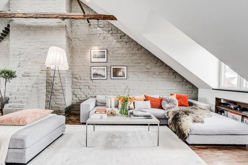 Inspiration for a large scandinavian open concept medium tone wood floor and brown floor living room remodel in Stockholm with white walls, no fireplace and no tv