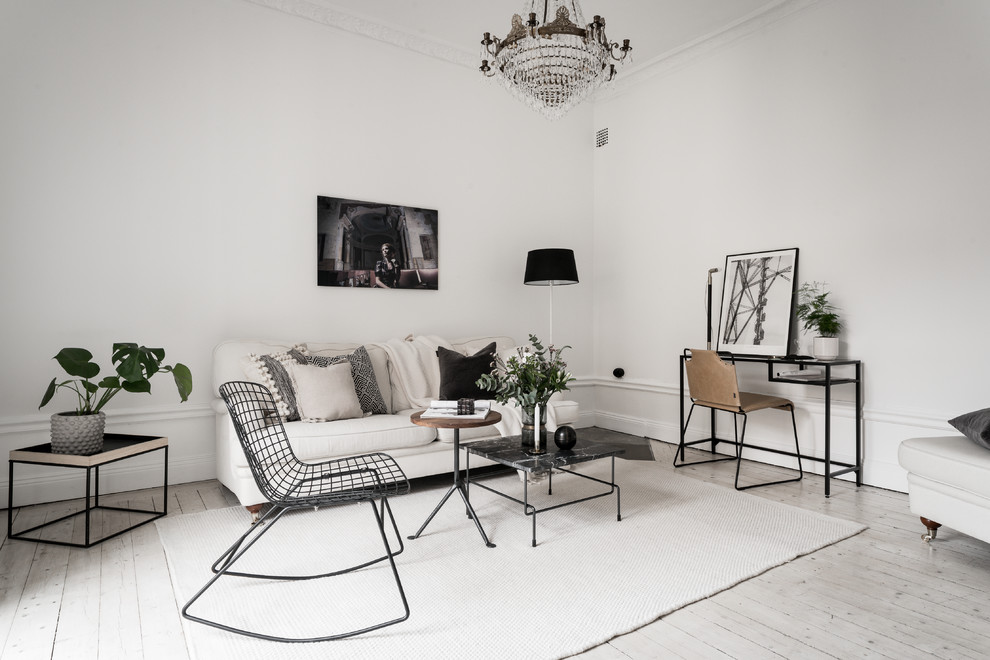 Photo of a scandi formal living room in Stockholm with white walls, light hardwood flooring and beige floors.