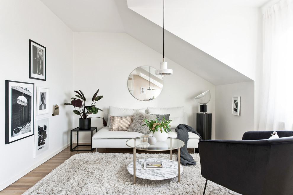 Small danish formal and loft-style light wood floor and beige floor living room photo in Gothenburg with white walls