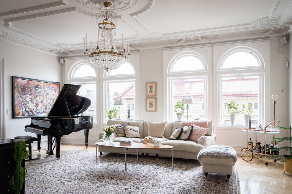 Photo of a traditional enclosed living room in Gothenburg with a home bar, white walls, light hardwood flooring and beige floors.