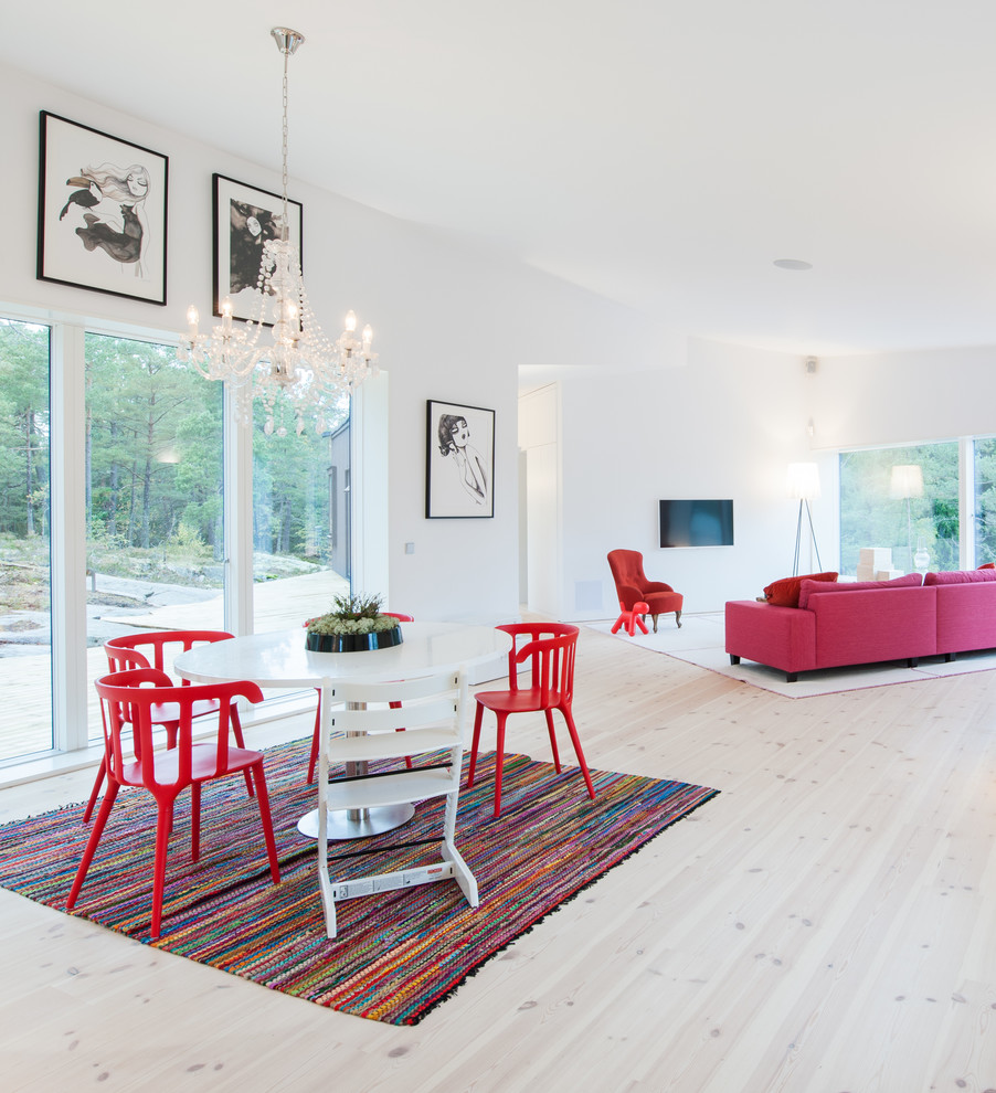 Large modern formal open plan living room in Stockholm with white walls, light hardwood flooring, no fireplace and no tv.