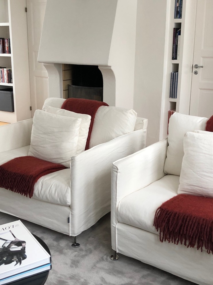 Idee per un soggiorno design di medie dimensioni con pareti bianche, stufa a legna e parete attrezzata